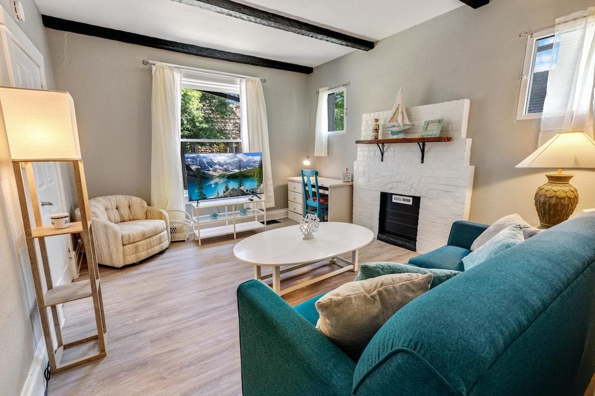 Living room space with a La-Z-boy sofa, HD TV, workspace with a desk, chair, and high-speed wi-fi.