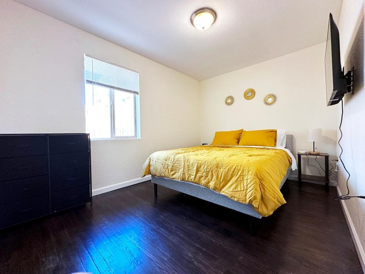 Bedroom with queen bed, dresser with storage for clothing